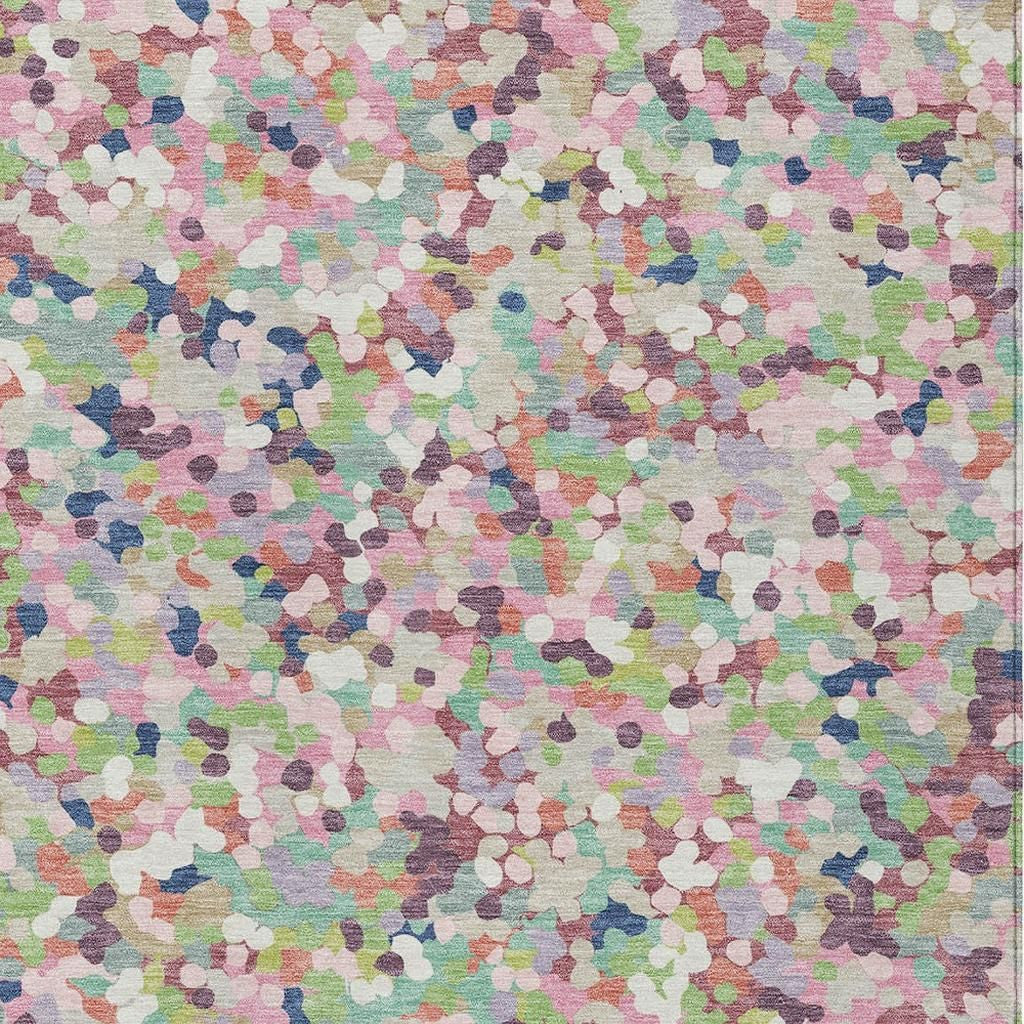 Pastel indoor/outdoor area rug with geometric confetti pattern in blush, pink, blue, green