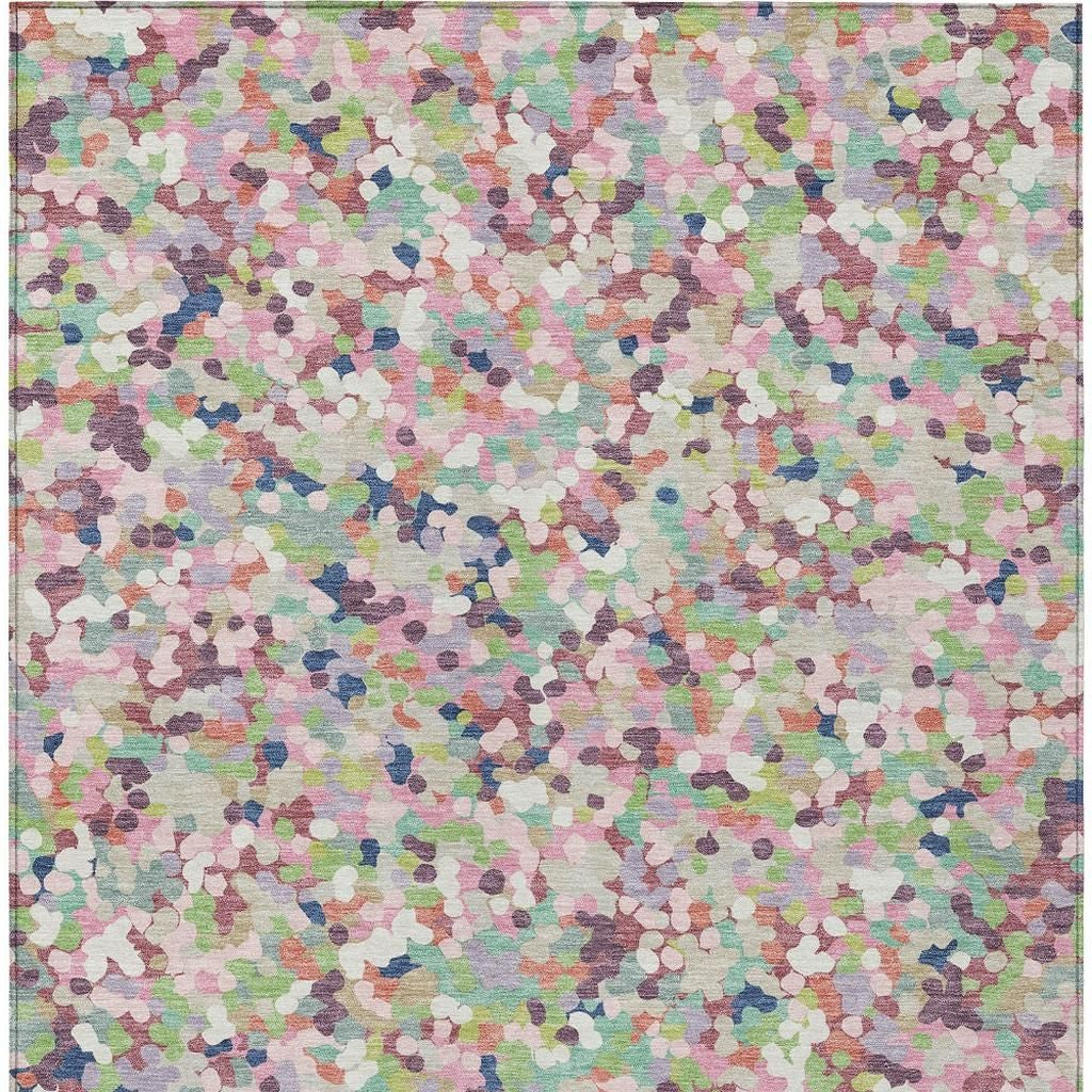 Indoor/outdoor area rug with multicolor geometric confetti pattern across a light background