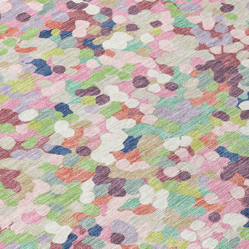 Close-up of pastel geometric confetti rug pile in blush, teal, purple, and orange