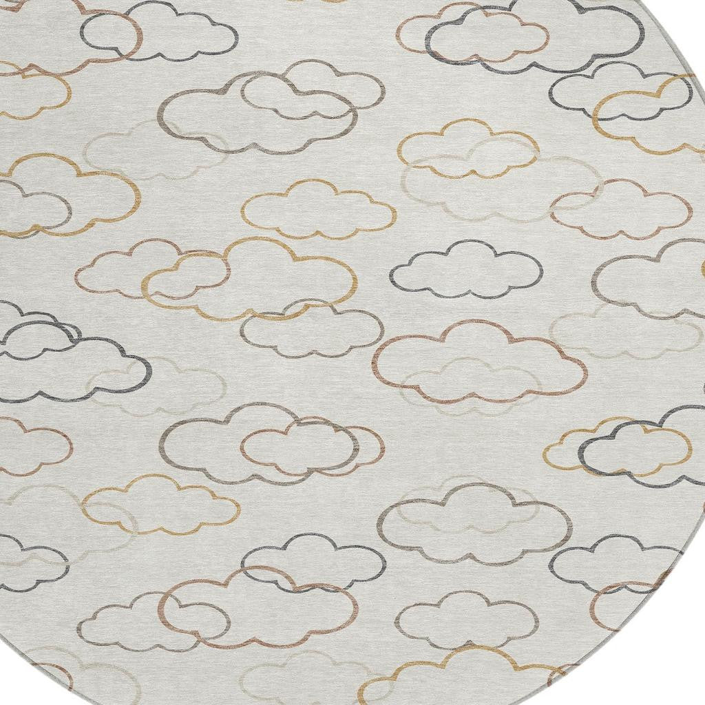 Round area rug with light gray cloud outline pattern in beige, tan, and blue-gray