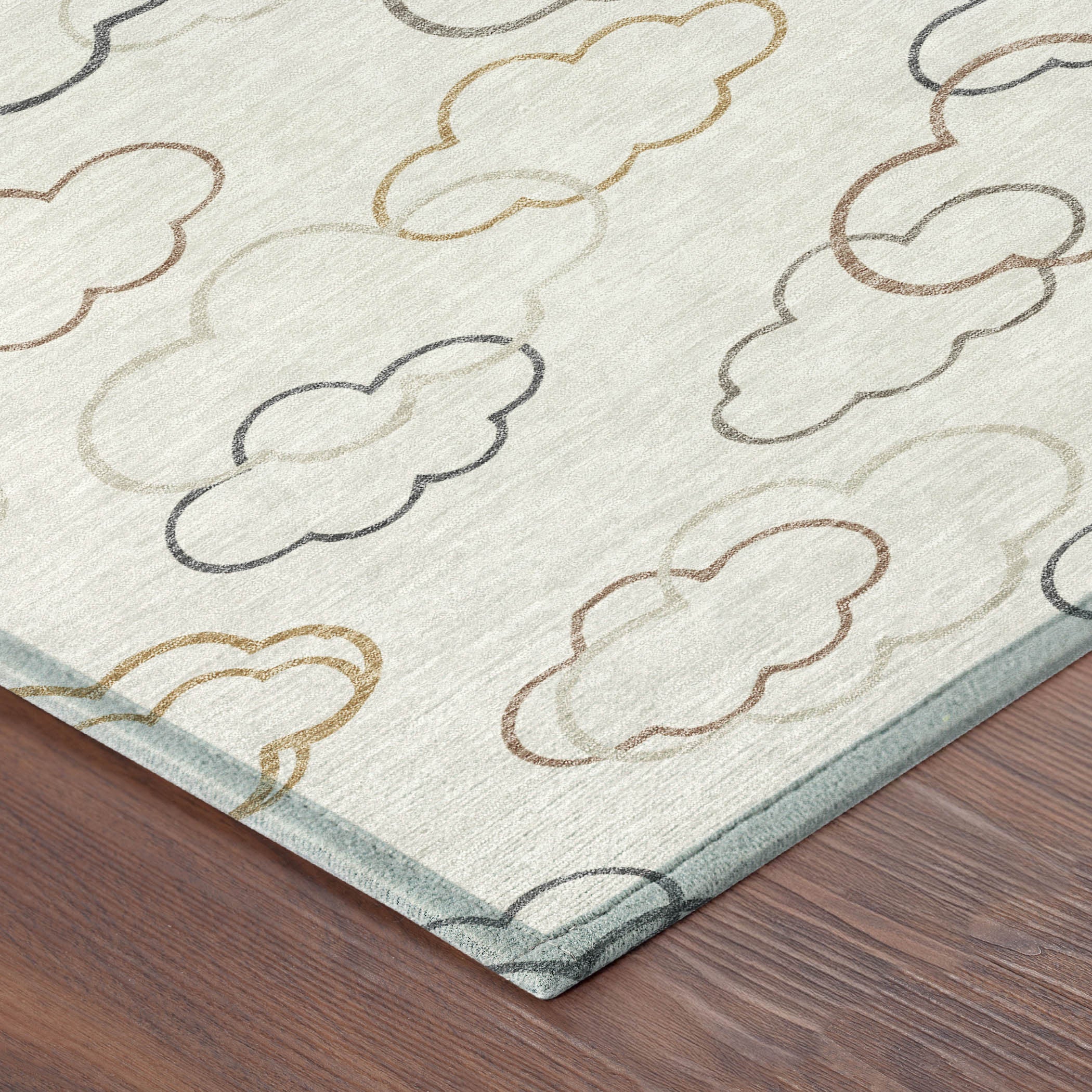 Close-up corner of round rug with cloud line pattern on light gray, multicolor