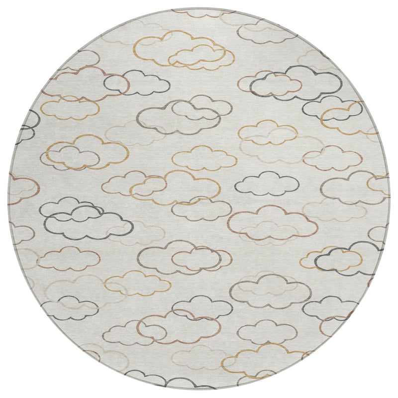 Round area rug with scattered cloud outlines in gray, tan, and gold on light gray