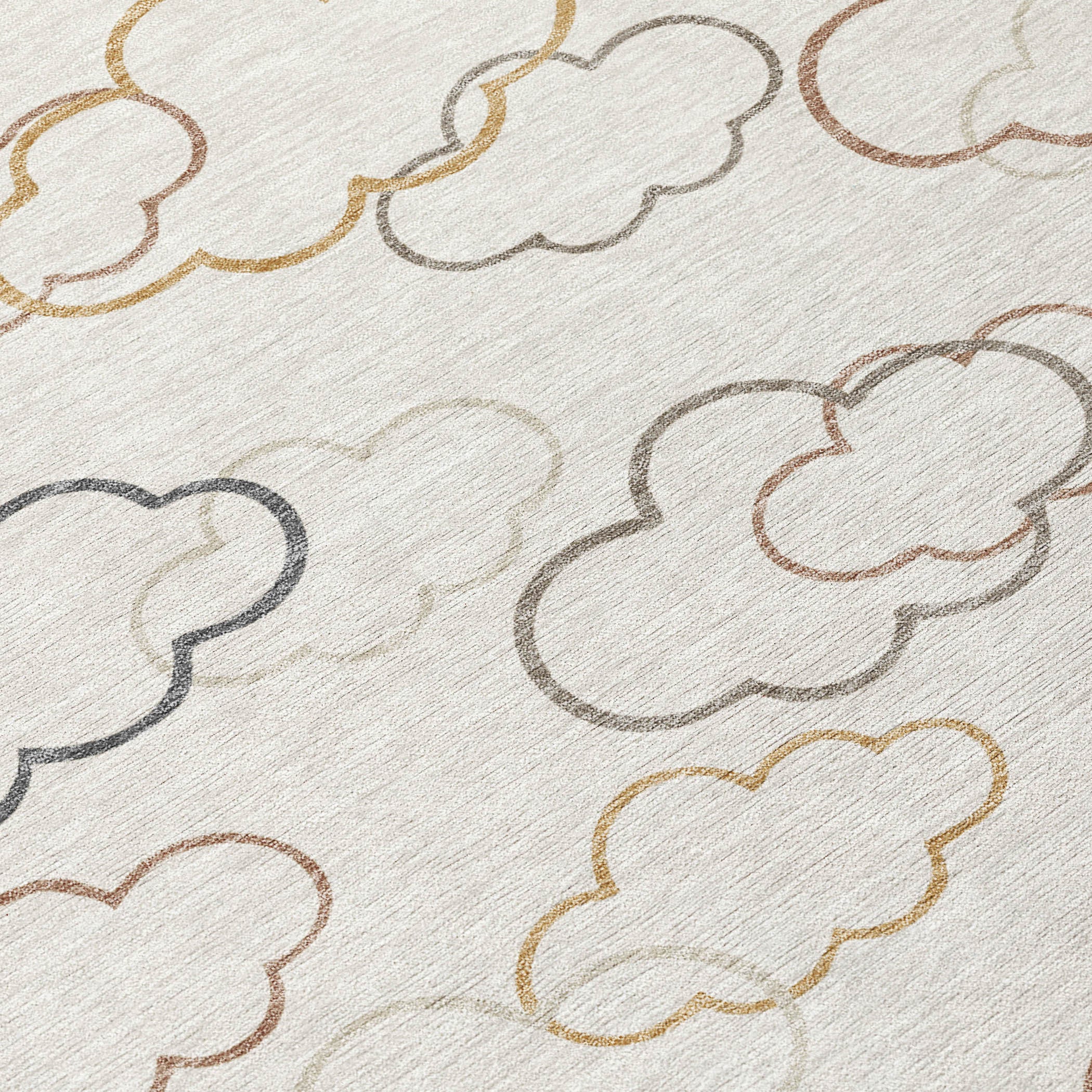 Rug surface close-up with cloud outlines in gray, tan, gold, and rust on light base