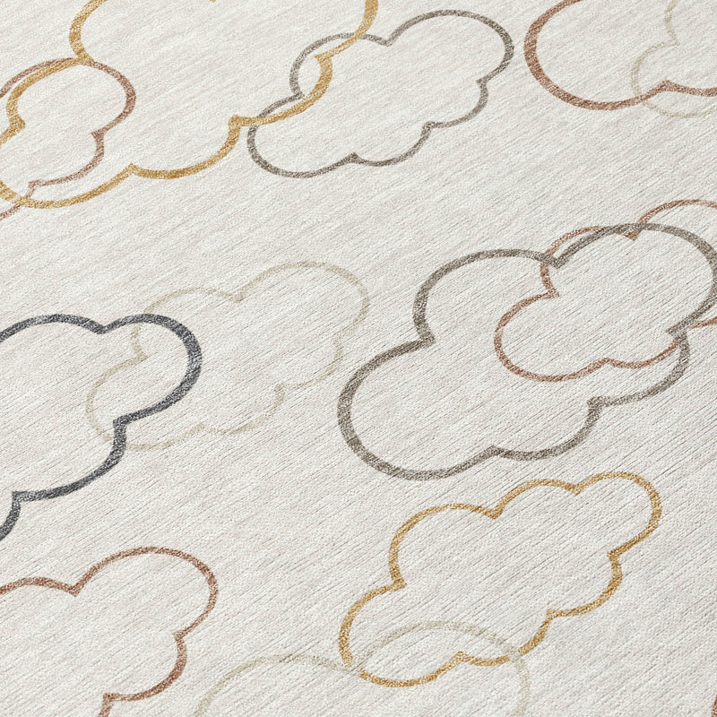 Rug surface close-up with cloud outlines in gray, tan, gold, and rust on light base
