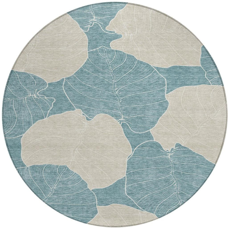 Round teal and ivory botanical area rug with repeating leaf shapes