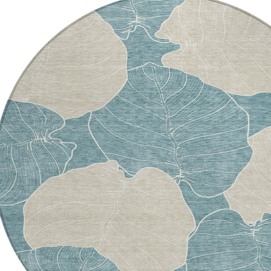 Round teal and ivory botanical area rug close-up of leaf outlines
