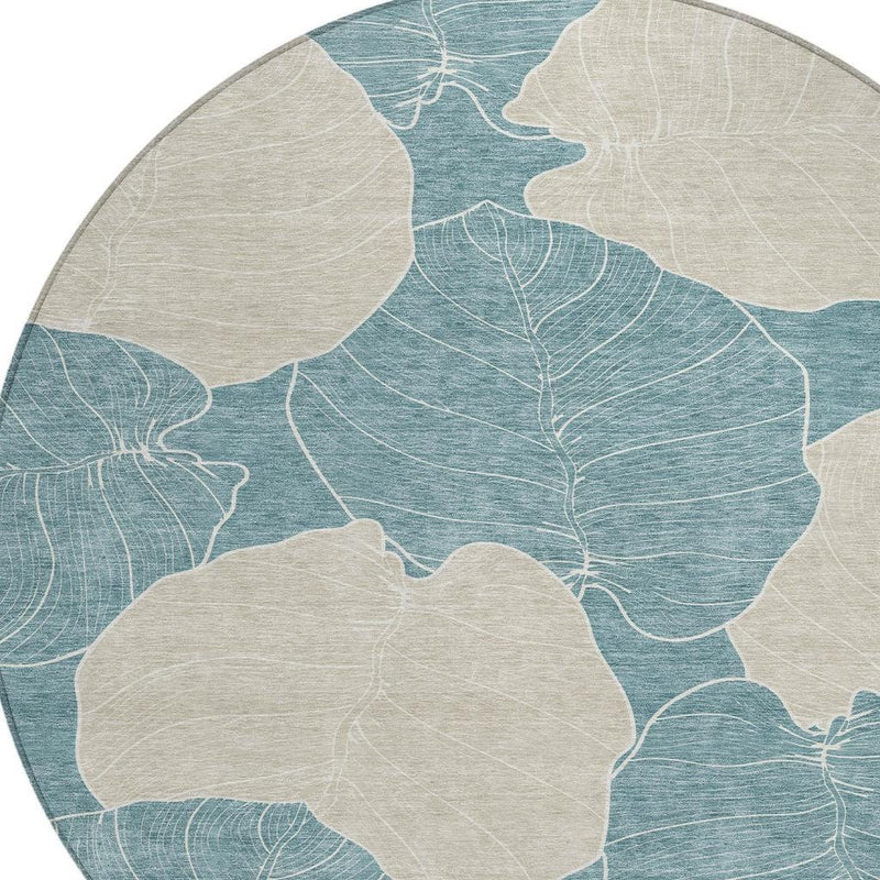 Round teal and ivory botanical area rug close-up of leaf outlines
