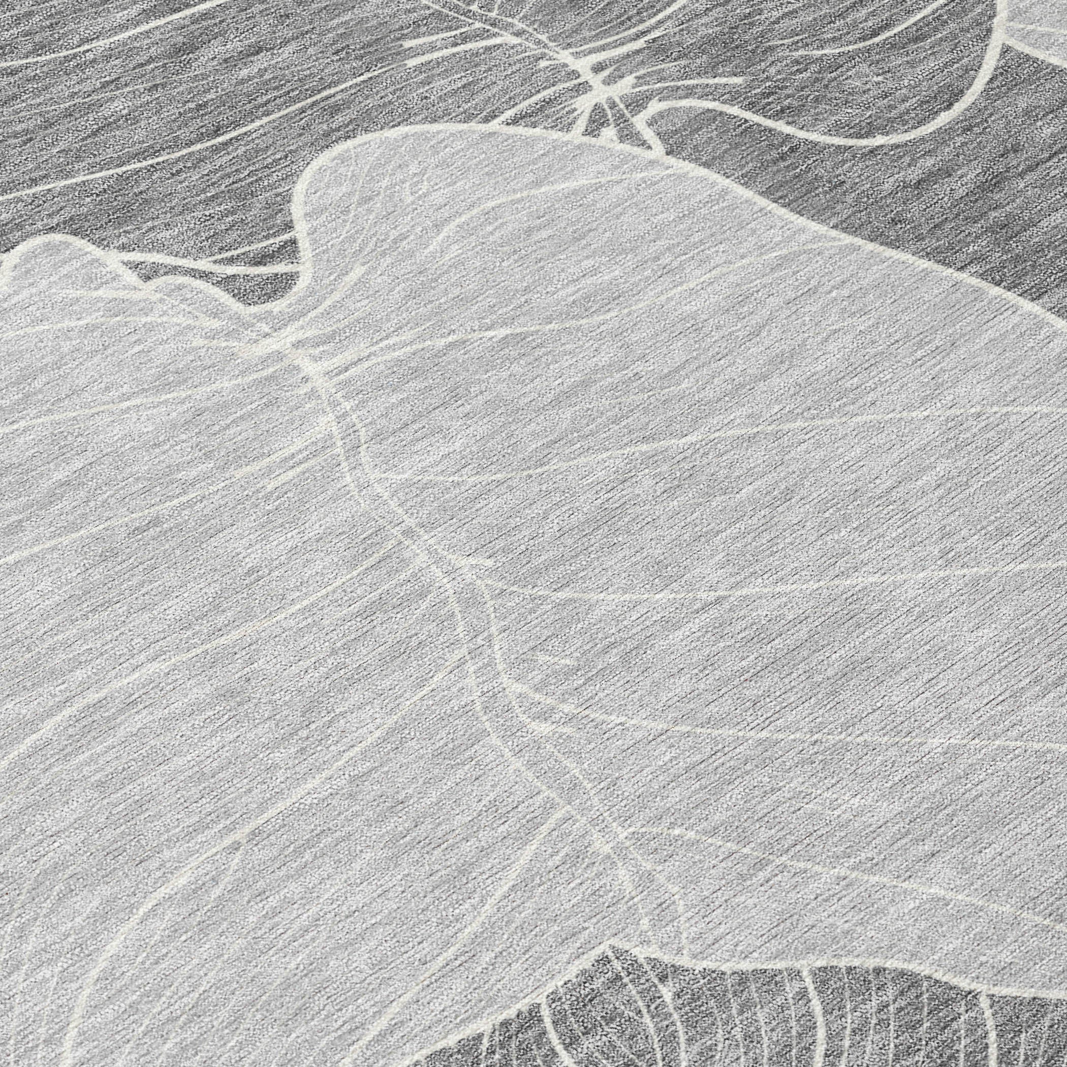 Close-up texture of gray and ivory leaf motif on washable area rug