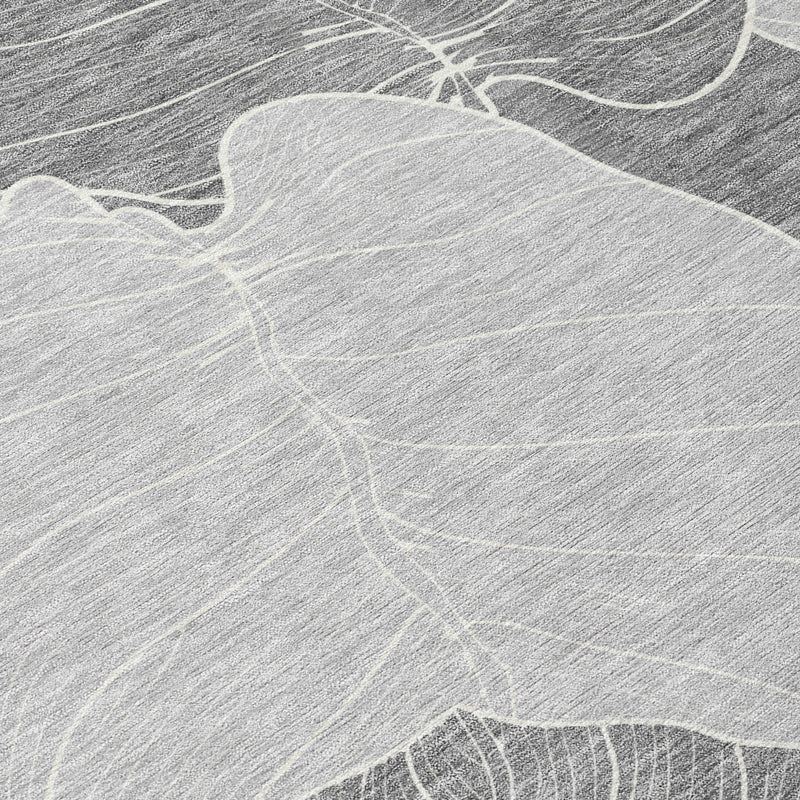 Close-up texture of gray and ivory leaf motif on washable area rug