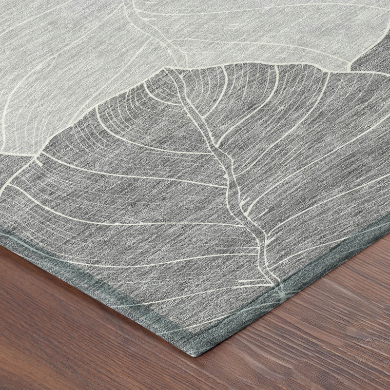 Corner view of gray and ivory leaf-pattern area rug with flat textured weave