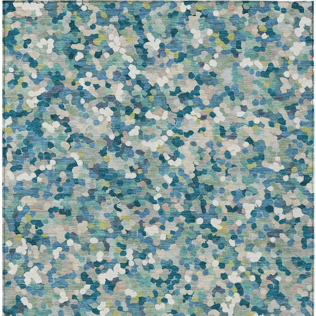 Teal blue geometric area rug with scattered abstract pattern in white and aqua tones