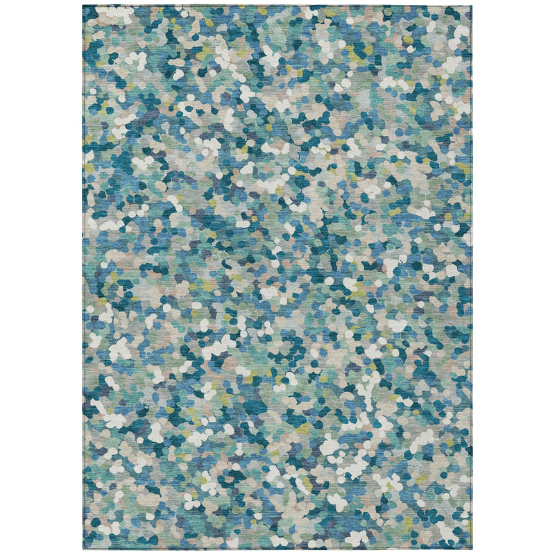 Teal blue geometric area rug with speckled abstract shapes in white, blue, and green