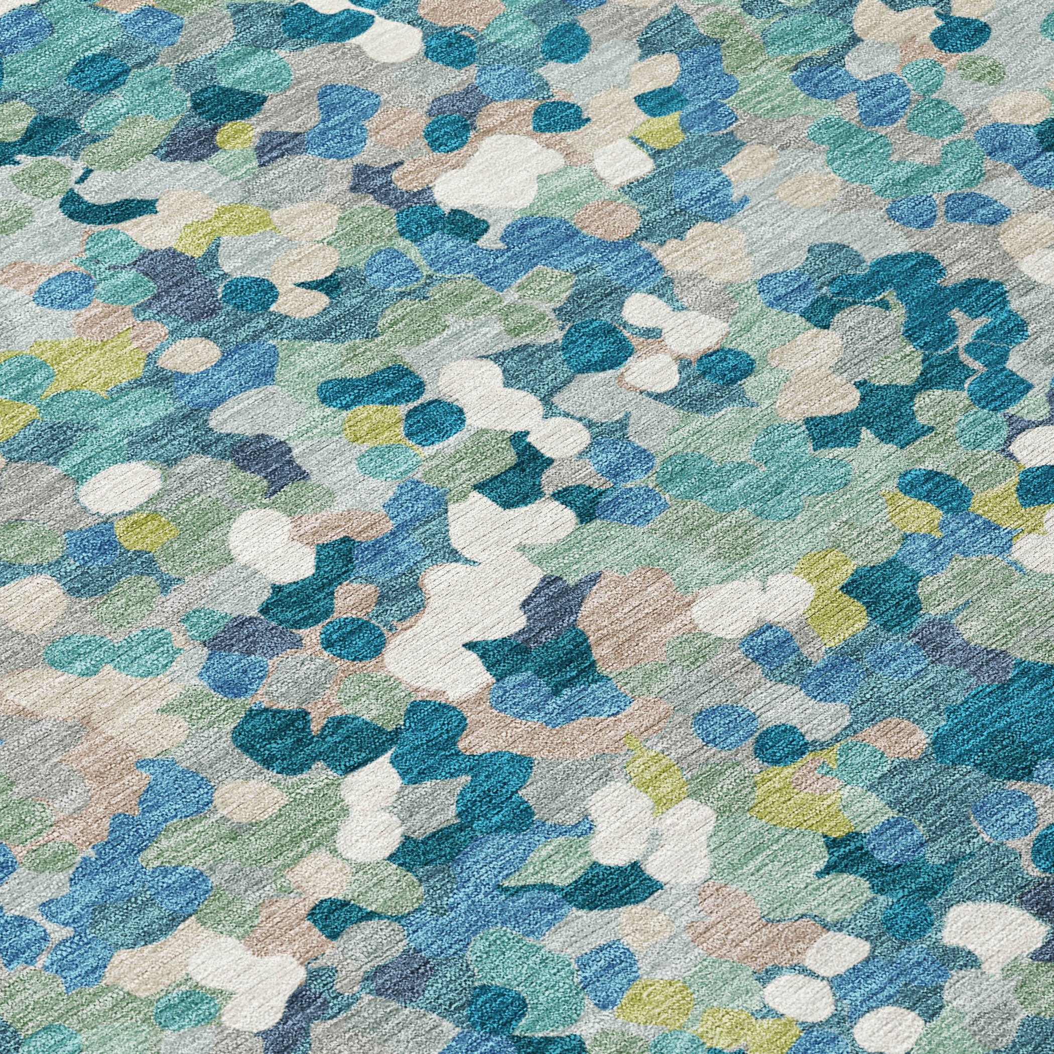 Teal blue geometric rug close-up with layered abstract shapes in white, green, and blue