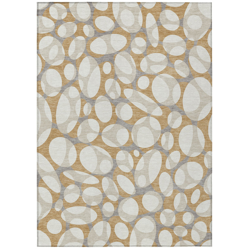 Abstract area rug with repeating white oval motifs on tan, beige, and gray