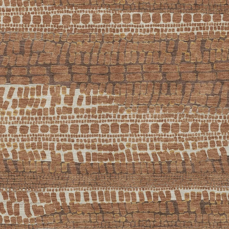 Rust and tan abstract area rug with repeating white brick-like blocks