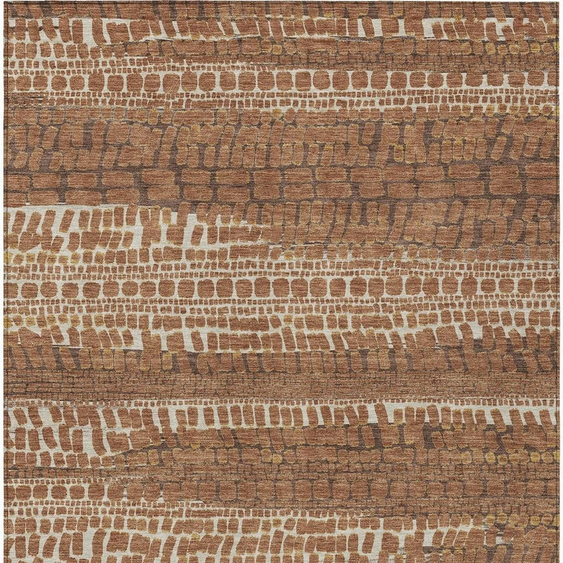 Close view of abstract brick pattern area rug in warm brown, tan, and cream