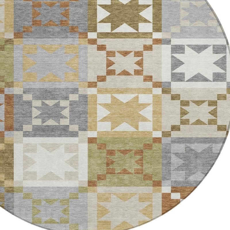 Partial close-up of round patchwork rug showing stacked star and checker blocks in gray, green, and tan.