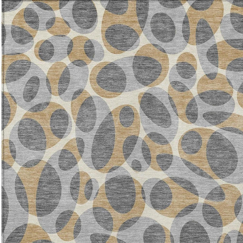 Abstract area rug close-up with gray and beige oval motif on a light base