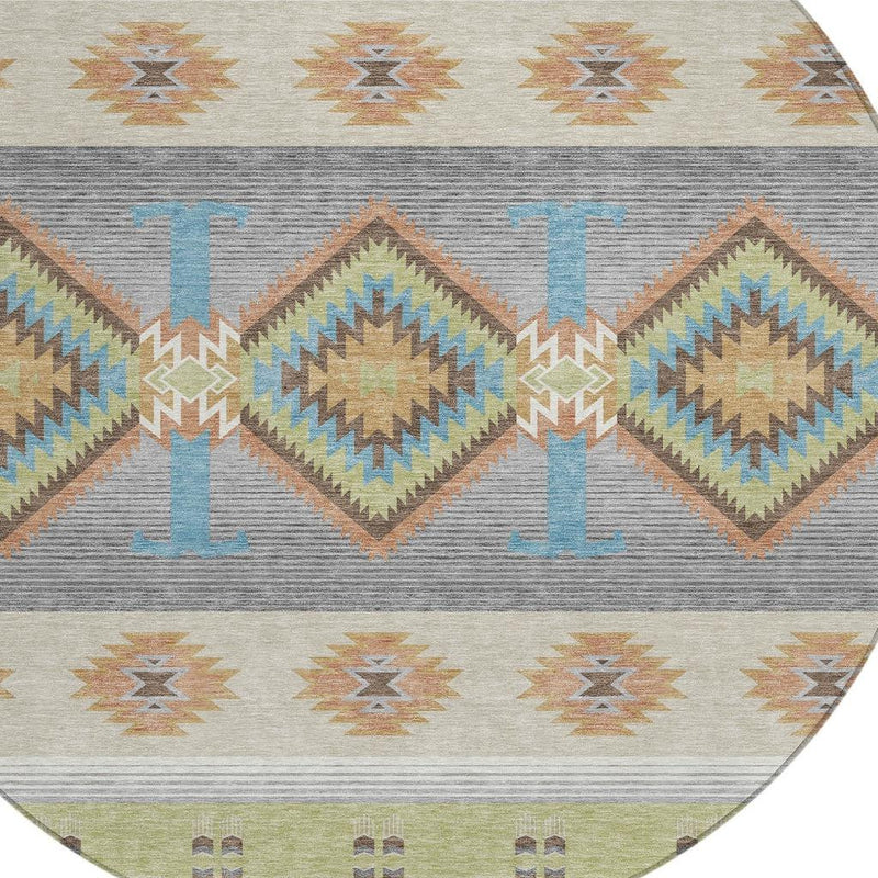 Round area rug close-up with diamond shapes, zigzag borders, and blue accents