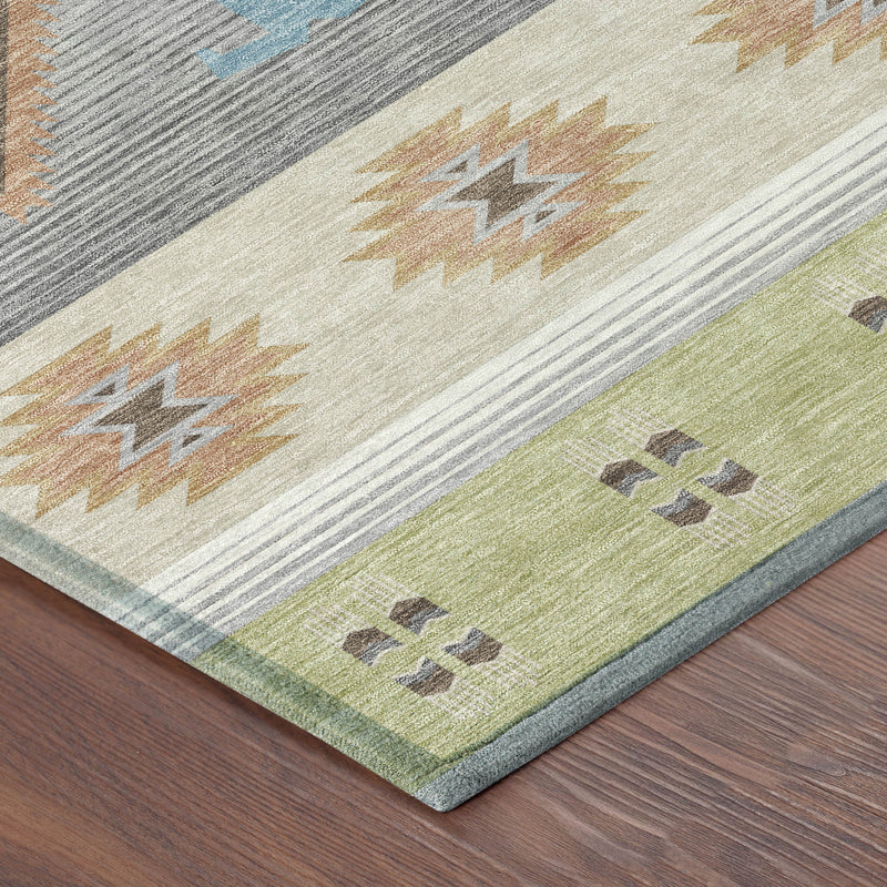 Corner of round area rug with southwestern geometric bands in gray, blue, tan, and green
