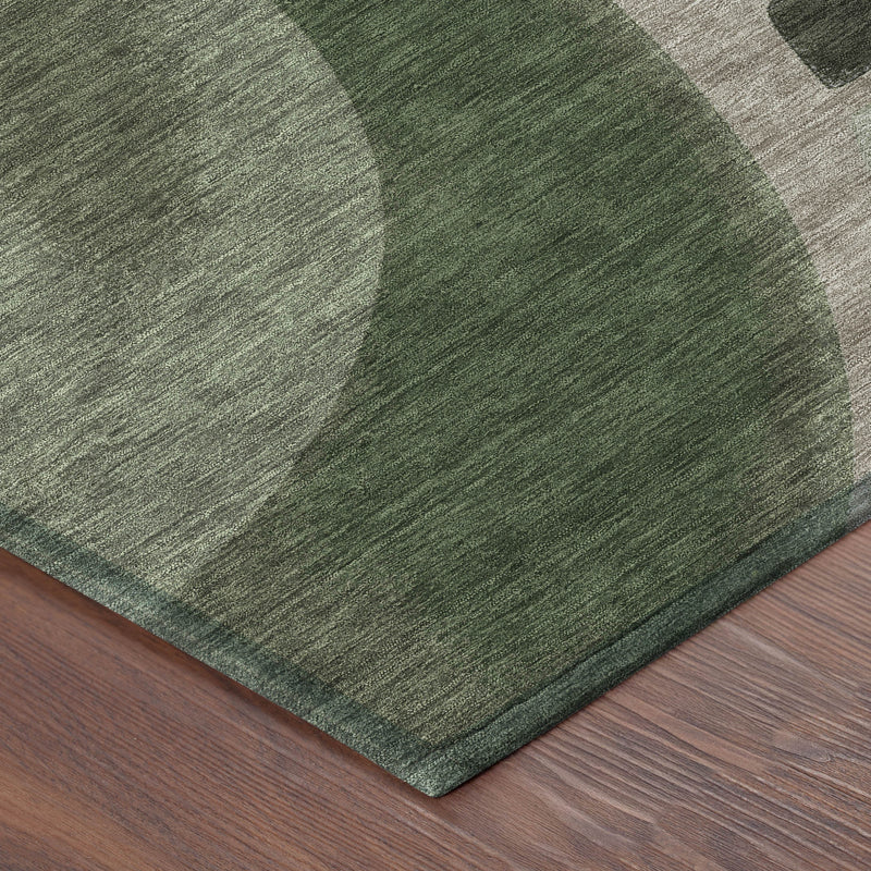 Corner view of rectangular area rug with textured abstract olive and green arcs