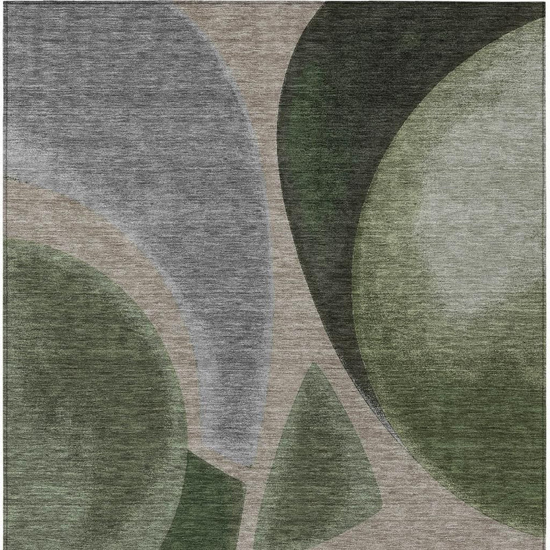 Abstract area rug with gray, white, and dark green curved blocks and arcs