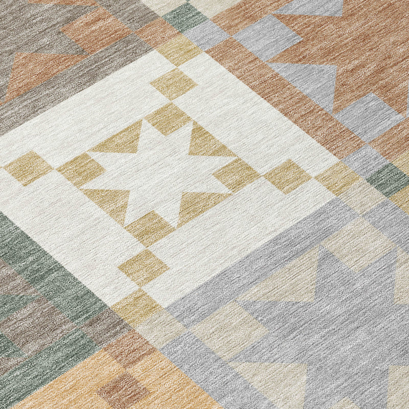 Patchwork area rug detail with large center star and diamond blocks in warm grays and tans