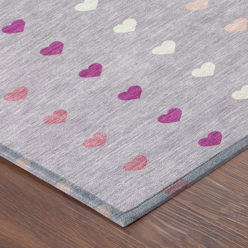 Corner of lavender area rug with multicolor hearts pattern and blue-gray edge