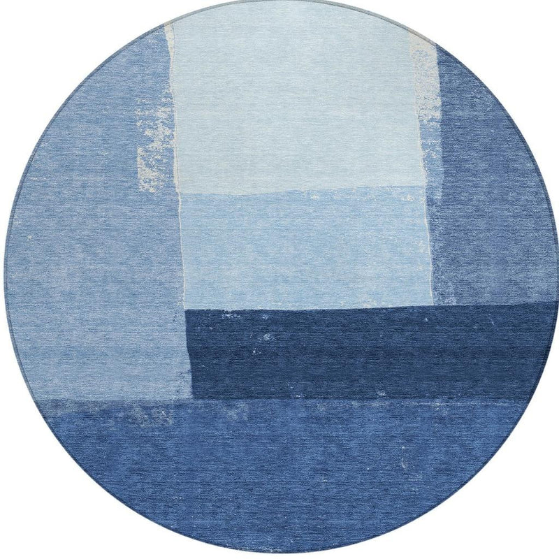 Round blue area rug with light square center and dark stripe sections
