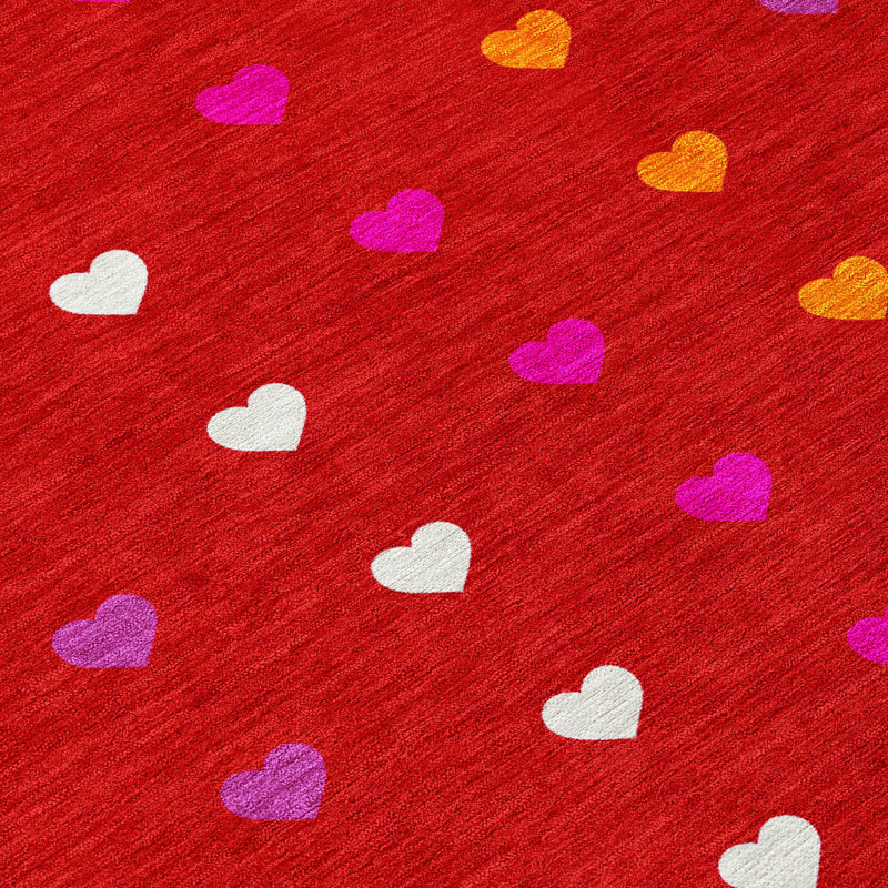 Red heart-pattern area rug close-up with purple, orange, yellow, and white hearts