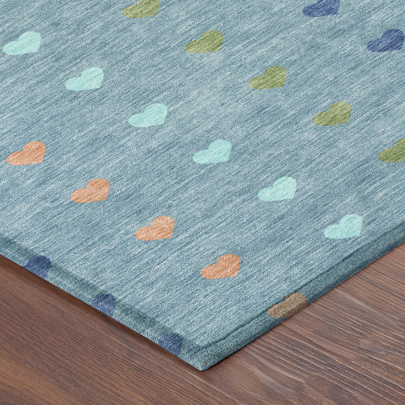 Teal blue area rug corner with multicolor hearts, low-pile texture
