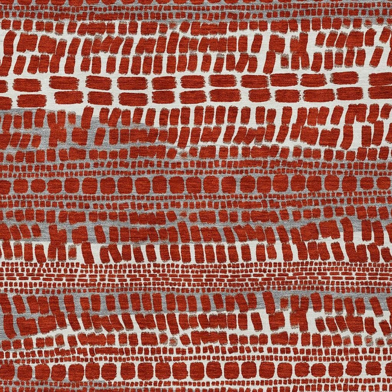 Red abstract area rug with repeating brick-pattern motif in white and gray.