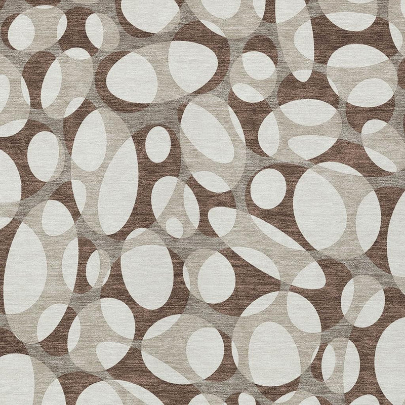 Chocolate and beige abstract oval area rug, close-up repeating pattern