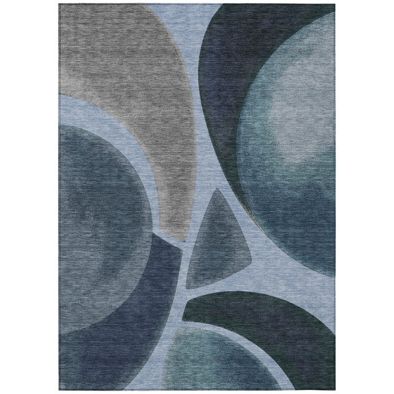 Abstract area rug with blue, gray, and light blue abstract shapes on white