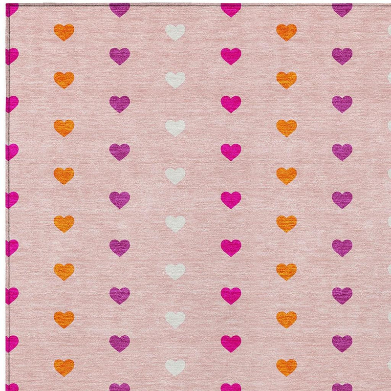 Pink heart-pattern area rug with purple and orange hearts, stitched edge border view