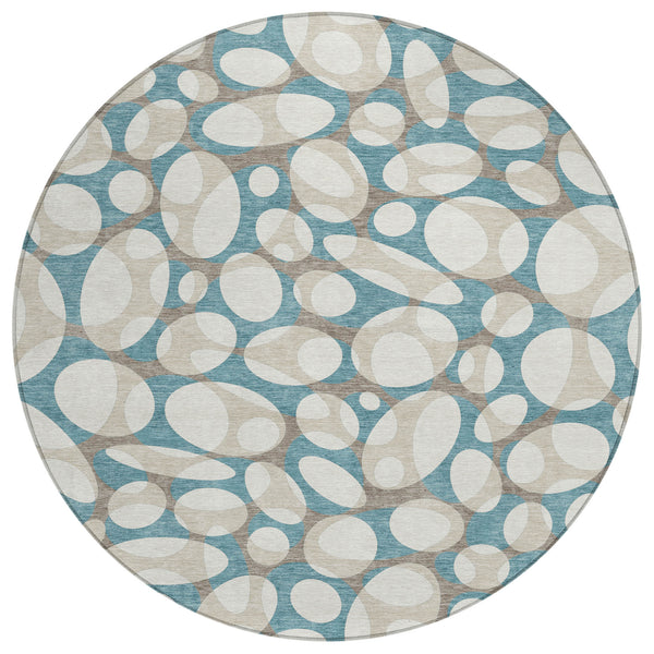 Round area rug with abstract oval pattern in teal blue and ivory, bordered edge