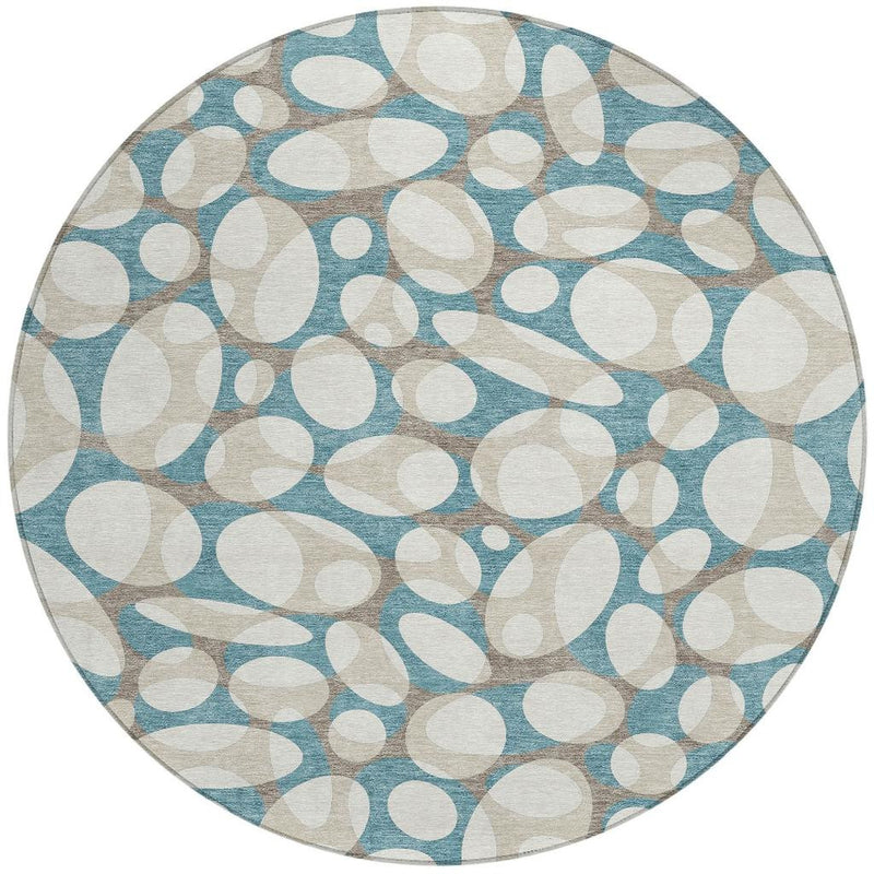 Round area rug, teal blue and ivory abstract oval motif with stitched border