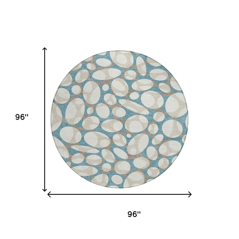 Round area rug with teal blue and ivory abstract oval pattern, flat lay