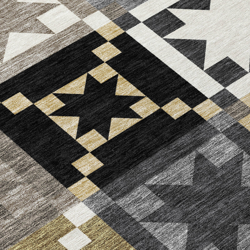 Geometric patchwork rug close-up in black, gray, white, and gold accents