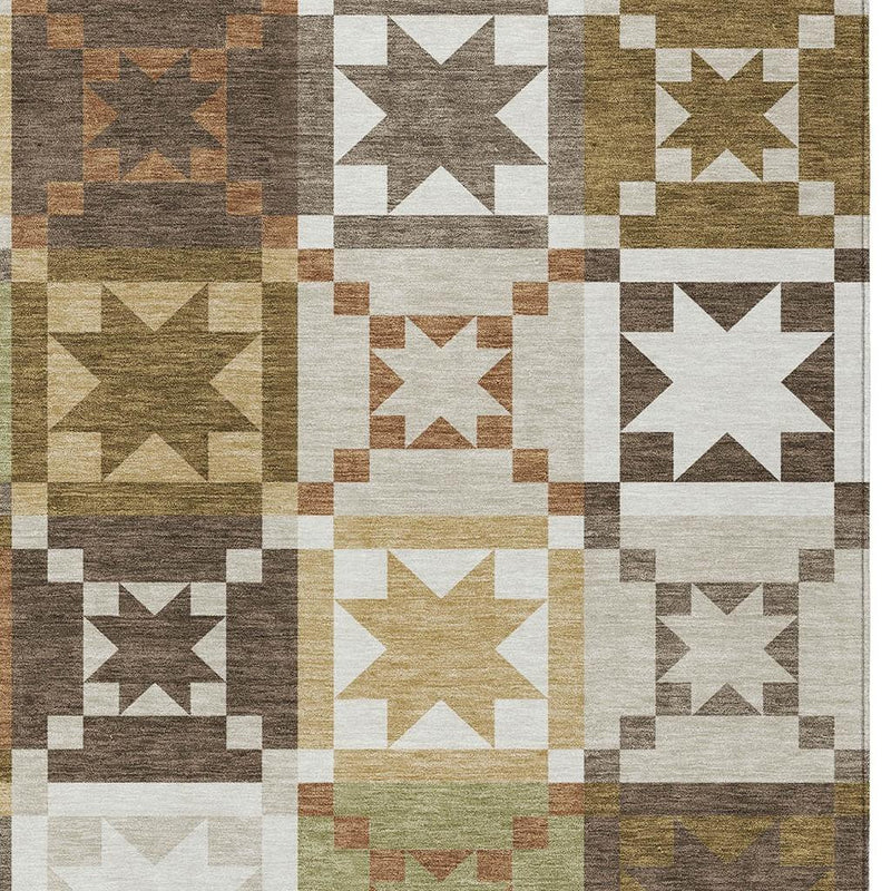 Geometric patchwork area rug with star blocks in cream, brown, green, and rust tones