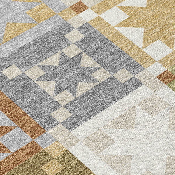 Patchwork area rug with gray, cream, and olive geometric shapes and small border blocks