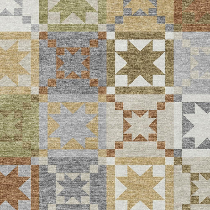 Patchwork rug with rectangular blocks and star designs in gray, cream, olive, tan, and rust