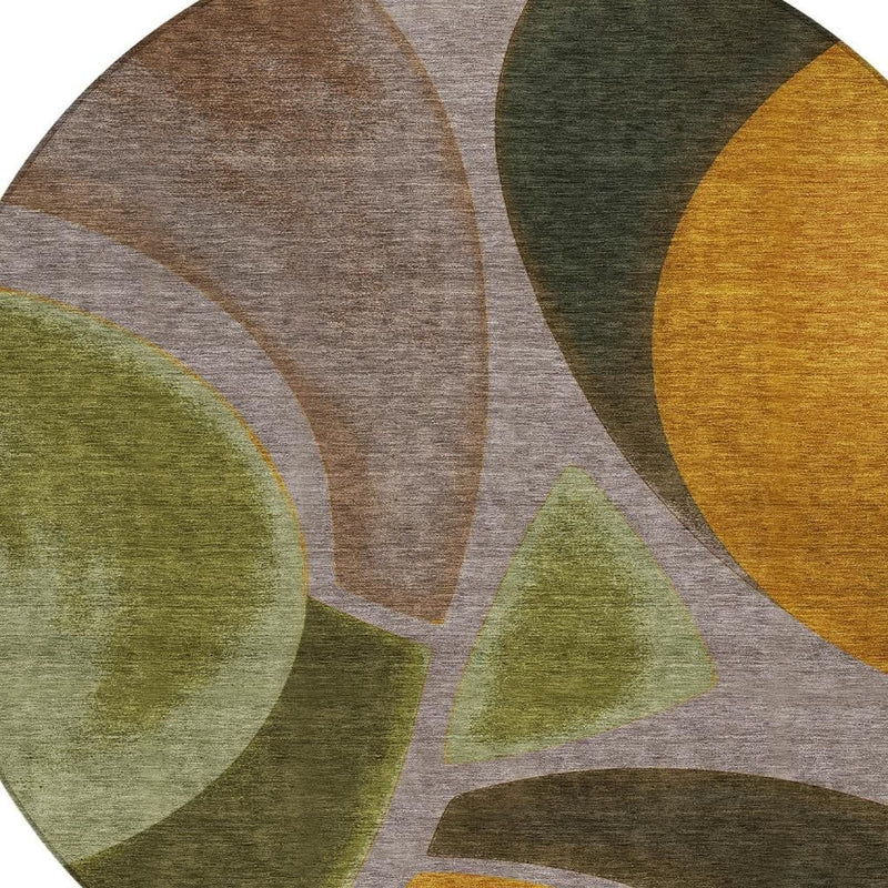 Round area rug with overlapping oval and triangle shapes in taupe, olive, and gold