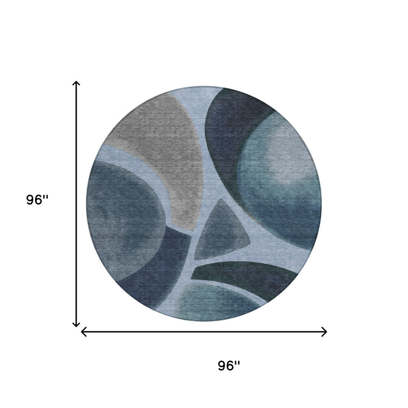 Round abstract area rug, 96 in wide, blue and navy curved pattern on gray