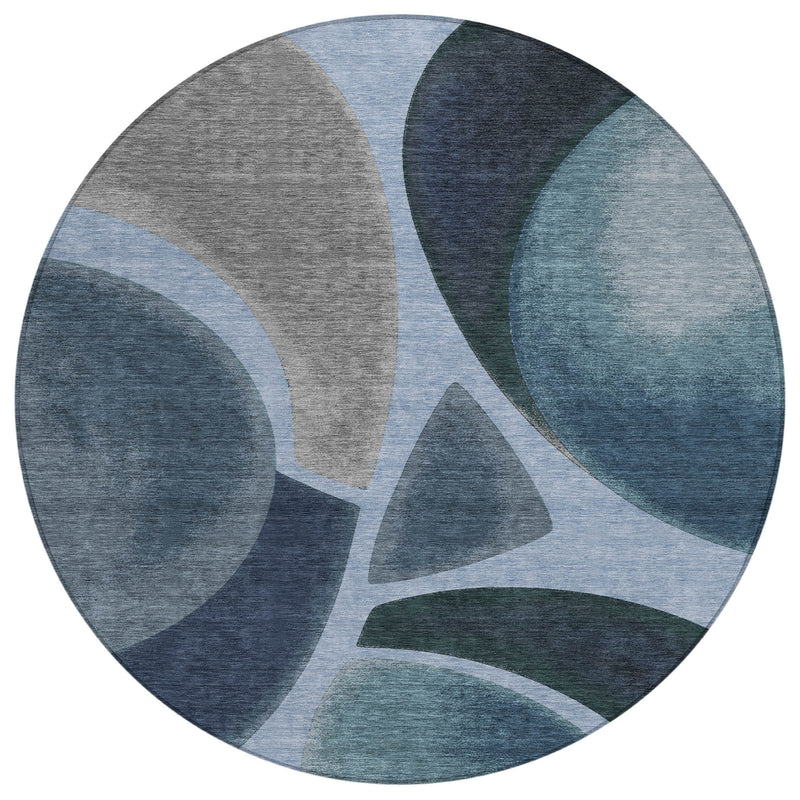 Round abstract area rug with blue, navy, and gray circular motif and soft texture