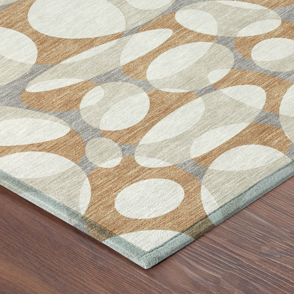 Washable indoor outdoor area rug with abstract oval pattern in ivory, copper, and gray