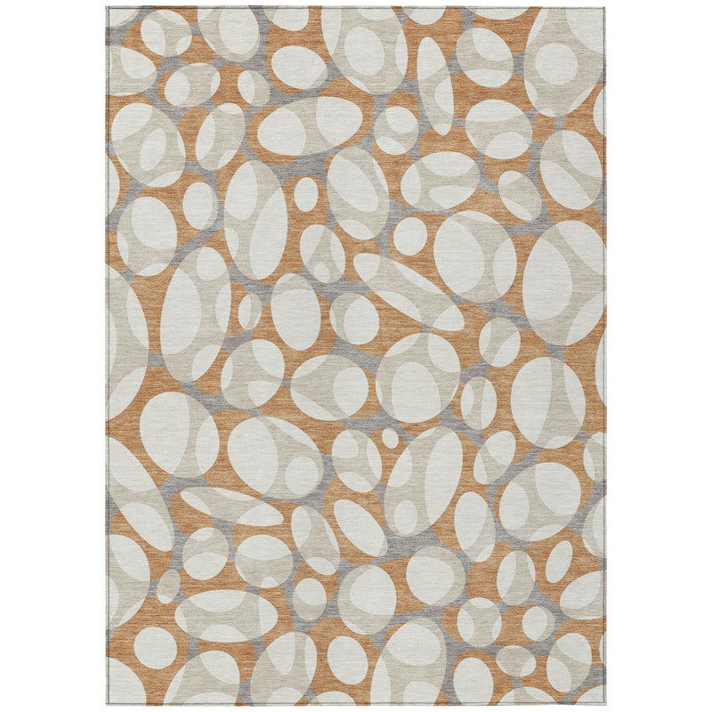 Rectangular area rug featuring repeating oval and ring shapes in ivory and copper with gray