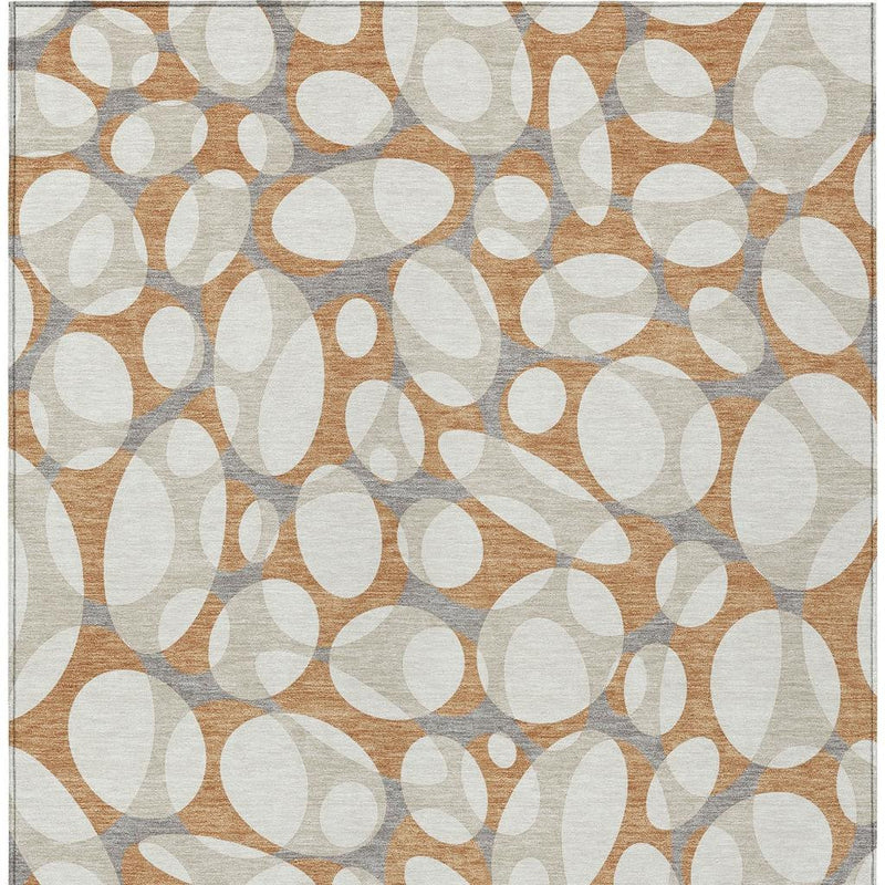 Abstract indoor outdoor area rug with dense oval pattern in ivory, copper, and gray tones