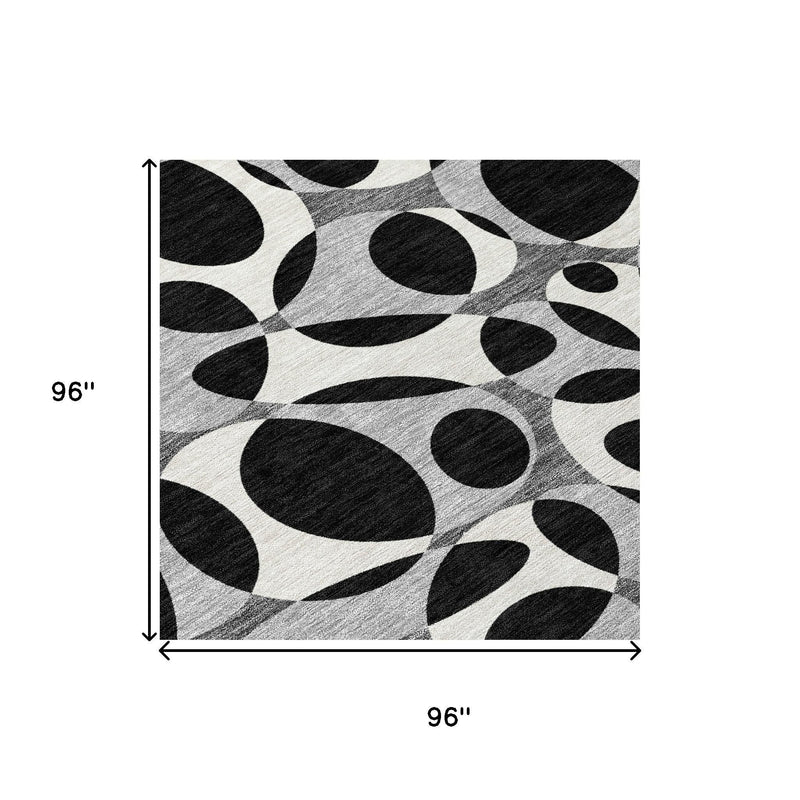 Round area rug measuring 96 in by 96 in, abstract black ovals on light gray