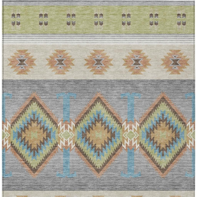 Southwestern area rug with border motifs and diamond patterns in green, gray, and blue.